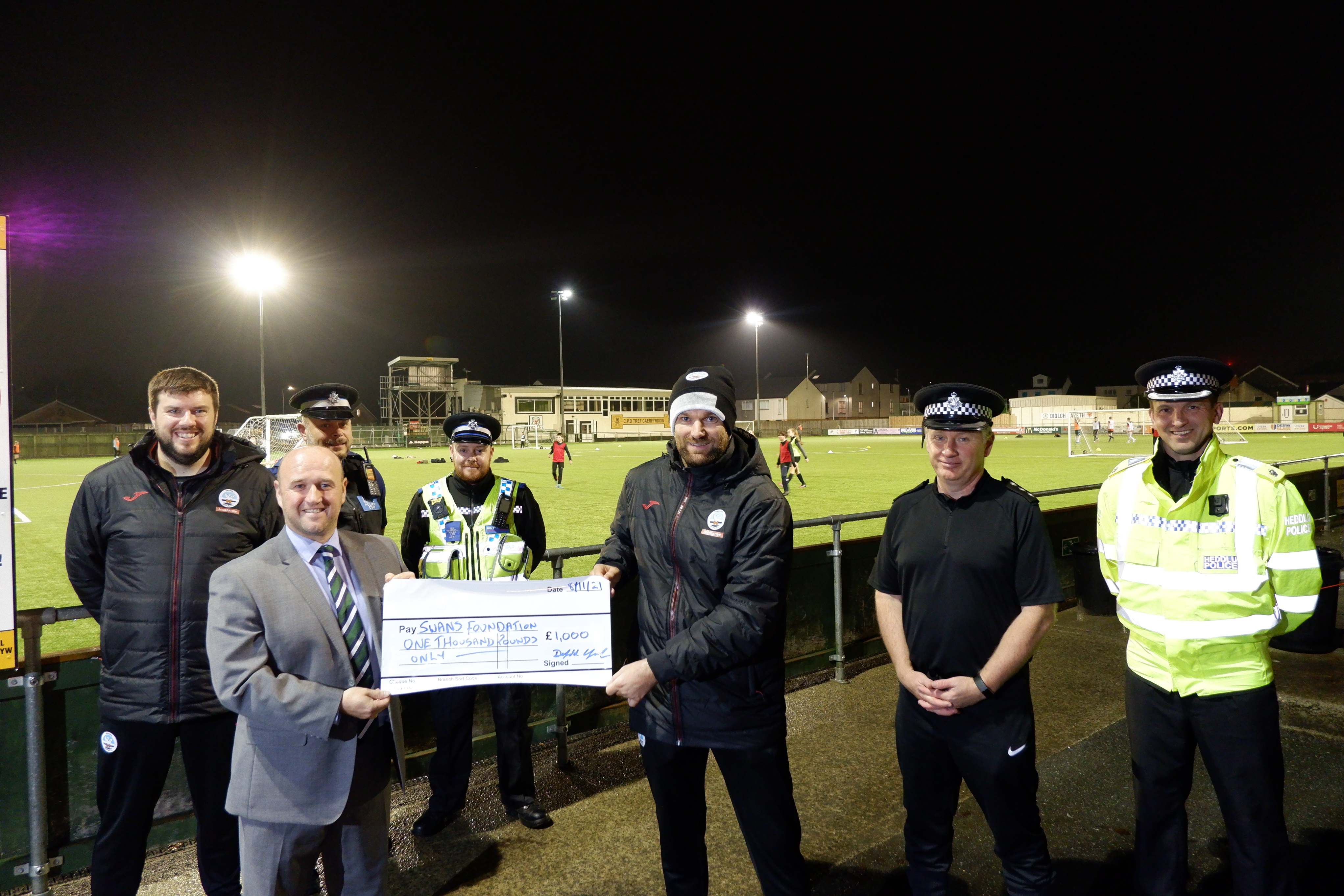 PCC Dafydd Llywelyn and Dyfed-Powys Police Officers present donation to Swansea City AFC Foundation on behalf of Force Charity Diogel