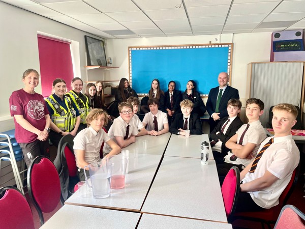 Picture of Police and Crime Commissioner Dafydd Llywelyn in a classroom with pupils from Ysgol Crickhowell High School.