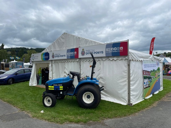 Image of OPCC stand at the Royal Welsh Show on Sunday July 21st showing the stand with tractor outside.
